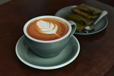 Selective focus cup of hot latte art coffee on wooden table Stock Photos