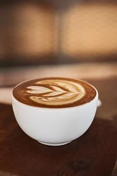 Selective focus cup of hot latte art coffee on wooden table Stock Photos