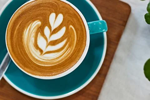 Selective focus cup of hot latte art coffee on wooden table Stock Photos