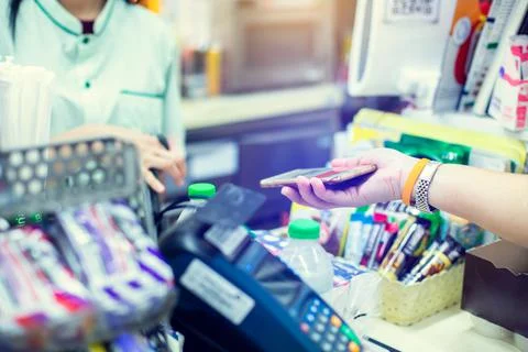 Selective focus to customer hand hold smartphone to payment in shop. Stock Photos