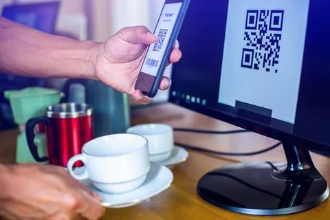 Selective focus to customer scan QR code to payment at cash register machine. Stock Photos