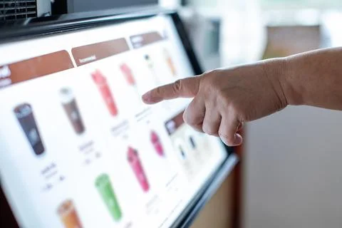 Selective focus to Customer using self service kiosk interactive touchscree.. Stock Photos
