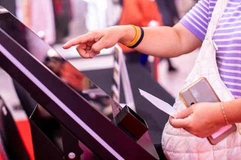 Selective focus to customer's hand is touching a touch screen and scan to t.. Stock Photos