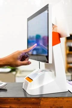 Selective focus to customer's hand is touching a touch screen to order food.. Фото