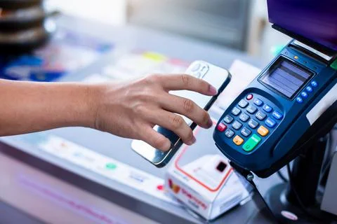 Selective focus to customer's hand is using mobile phone to scan to pay Stock Photos