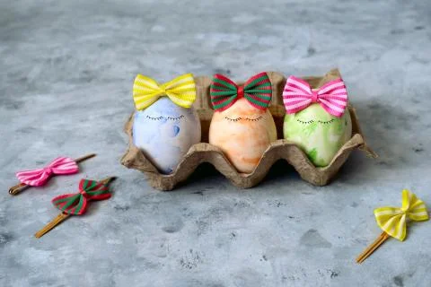 Selective focus cute blue,orange  and green Easter eggs in funny bows Stock Photos