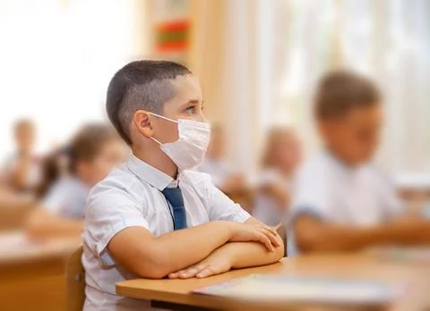 Selective focus on cute schoolboy doing schoolwork at classroom desks Stock-Fotos