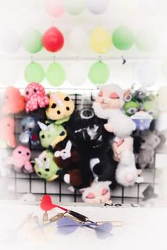 Selective focus on darts sitting on a ledge with a wall of balloon targets and Stock Photos