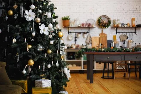 Selective focus. Decorated Christmas tree with toys and gifts and garland lig Stock Photos