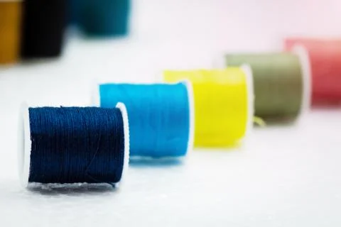 In selective focus of deep blue color roll of thread on background,needlework 写真素材