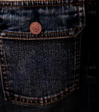 Selective focus on denim jean jacket pocket in clothes shop. Denim jacket poc 库存照片