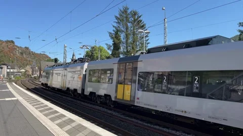 Selective focus departing passenger train from railway station platform Stock Footage 344954603
