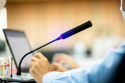Selective focus to desktop wireless conference microphones with blurry busine Stock Photos