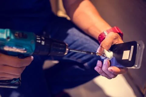 Selective focus to digital door lock pad with blurry hand of a mechanic. Stock Photos