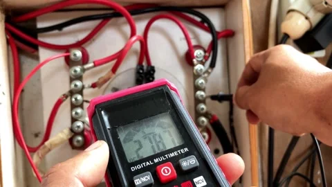 Selective focus of a digital multimeter testing electrical wiring. Stock Footage 345864991