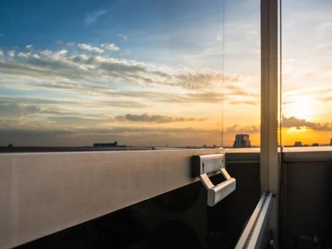 Selective focus on door handle with dramatic sunset blue and orange sky refle Stock Photos