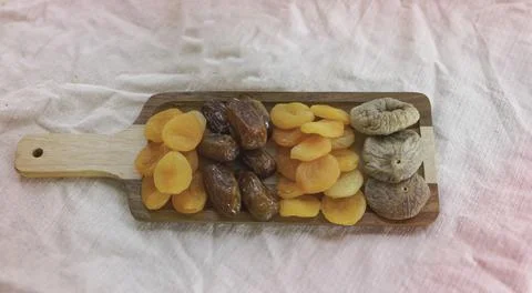 In selective focus of dried fruit put on wooden tray Stock Photos