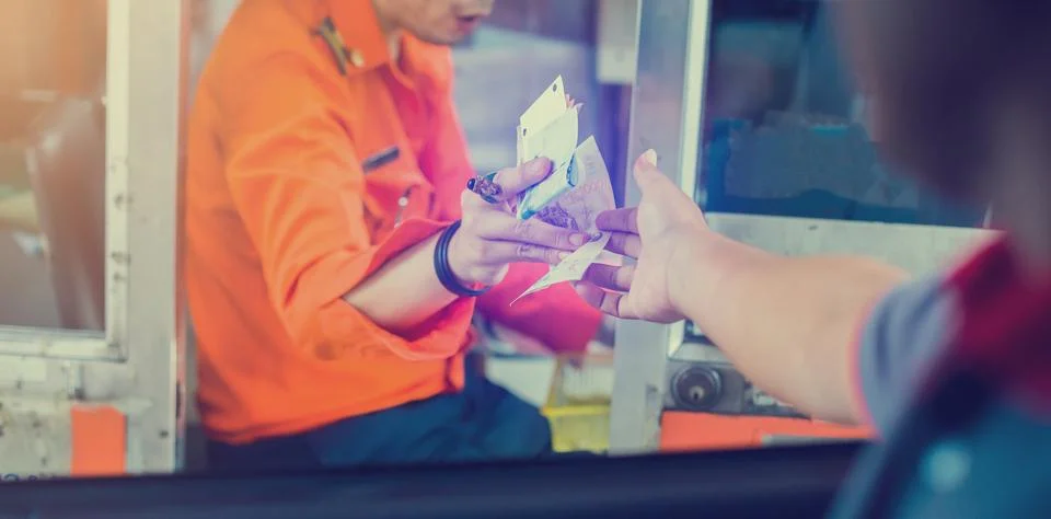 Selective focus to driver pay for the expressway. Man pays money to a cashier Stock Photos