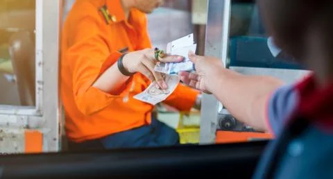 Selective focus to driver pay for the expressway. Man pays money to a cashier Stock Photos