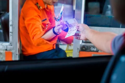 Selective focus to driver pay for the expressway. Man pays money to a cashier Stock Photos