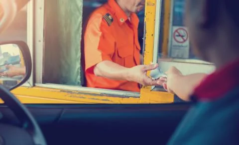 Selective focus to driver pay for the expressway. Man pays money to a cashier Stock-Fotos