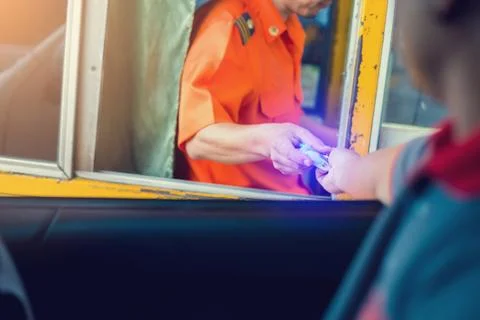 Selective focus to driver pay for the expressway. Man pays money to a cashier Stock Photos