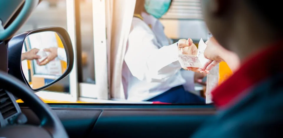Selective focus to driver pay for the expressway. Man pays money to a cashier Stock Photos