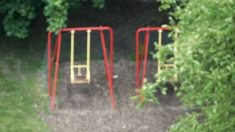 Selective focus on drops of rain on background children's Playground on street Stock Footage 132081620