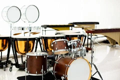 Selective focus to drum set with blurry marching band instrument in musical s Stock Photos