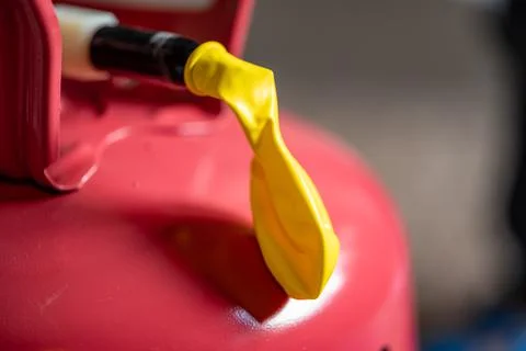 Selective focus on edge of an inflatable balloon attached to a helium canister. Stock Photos