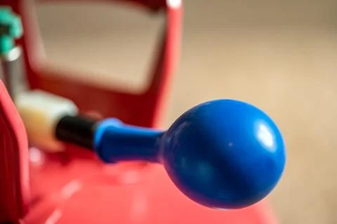 Selective focus on edge of an inflatable balloon attached to a helium canister. Stock Photos