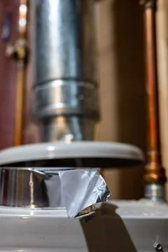 Selective focus on the edge of a roll of metallic aluminum foil HVAC duct tape Stock Photos