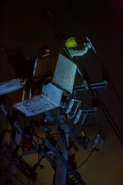 Selective focus to electrical worker is connecting high-voltage cable with a  Stock Photos