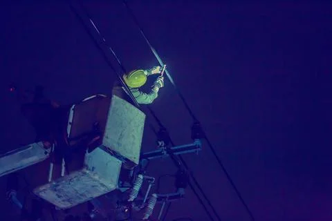 Selective focus to electrical worker is connecting high-voltage cable with a  Stock Photos