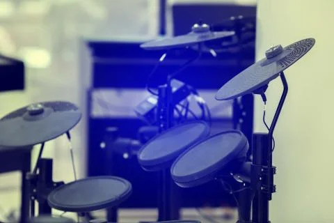 Selective focus to electronic cymbals of electronic drum set in music room. Stock Photos