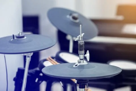Selective focus to electronic cymbals of electronic drum set in music room. Stock Photos