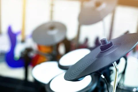 Selective focus to electronic cymbals of electronic drum set in music room. Stock Photos