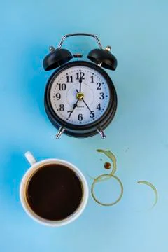 Selective focus: an electronic watch and a Cup of coffee on a colored backgro Stock Photos