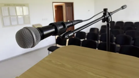 Selective focus on empty auditorium with microphone prepared for speech Stock Footage 313713198
