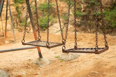 Selective focus of Empty spooky swing in desolate park. Stock-Fotos