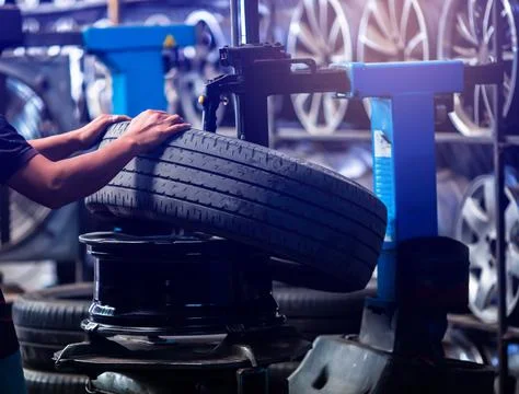 Selective focus to engineer balancing car wheel on balancer in workshop. Mech Stock Photos