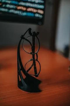 A selective focus of eyeglasses on blurred background of a computer displayin Stock-Fotos