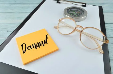 Selective focus of eyeglasses, compass and memo note written with DEMAND Stock Photos