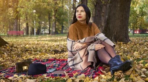 Selective focus of fall picnic on october. Young woman resting in nature with Stock Photos