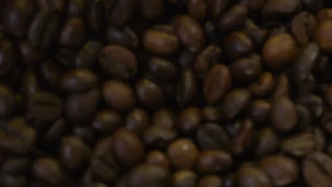 Selective focus. Falling coffee beans in slow motion. Smoke emanates from 스톡 동영상 324863742