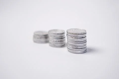 Selective focus featuring three vertical stacks of silver metal coins arran.. Stock Photos