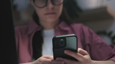 Selective focus of female use mobile phone app and computer to work or study Stock Footage 236821001