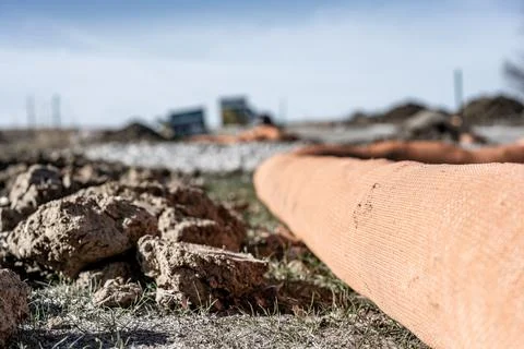 Selective focus on filter sock around exposed dirt at a construction site to Stock Photos