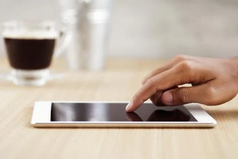 Selective focus finger touching on digital tablet Stock Photos