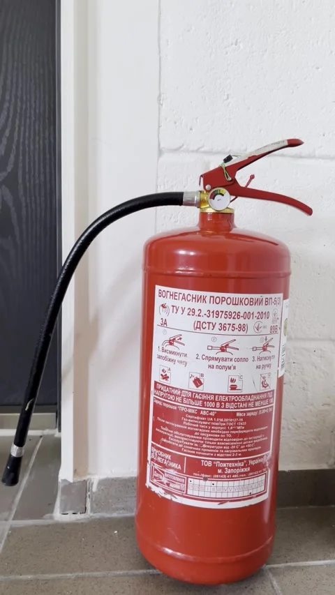 Selective focus on fire safety preparedness with extinguisher indoors Stock Footage 313713836